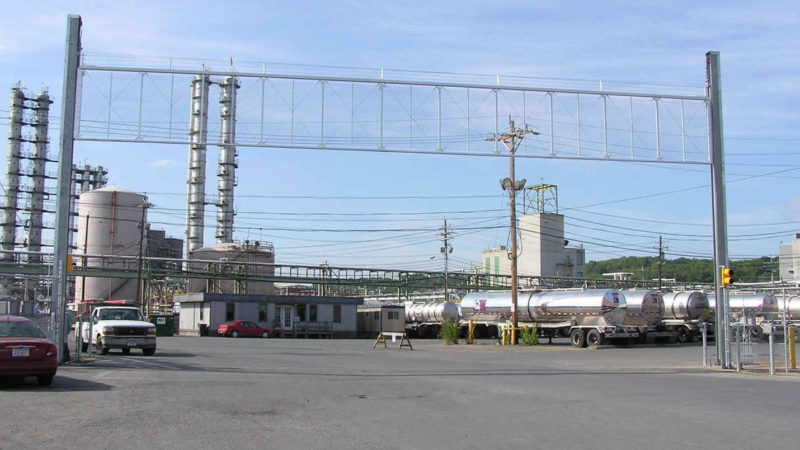 aluminum vertical lift gate security barrier system in the open position allowing a pickup truck to leave a protected facility